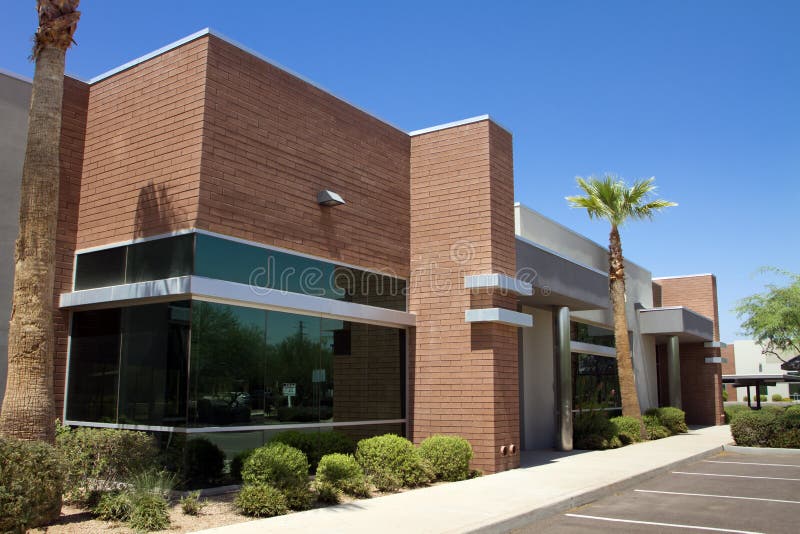 Modern corporate office building entrance in office park. Modern corporate office building entrance in office park.