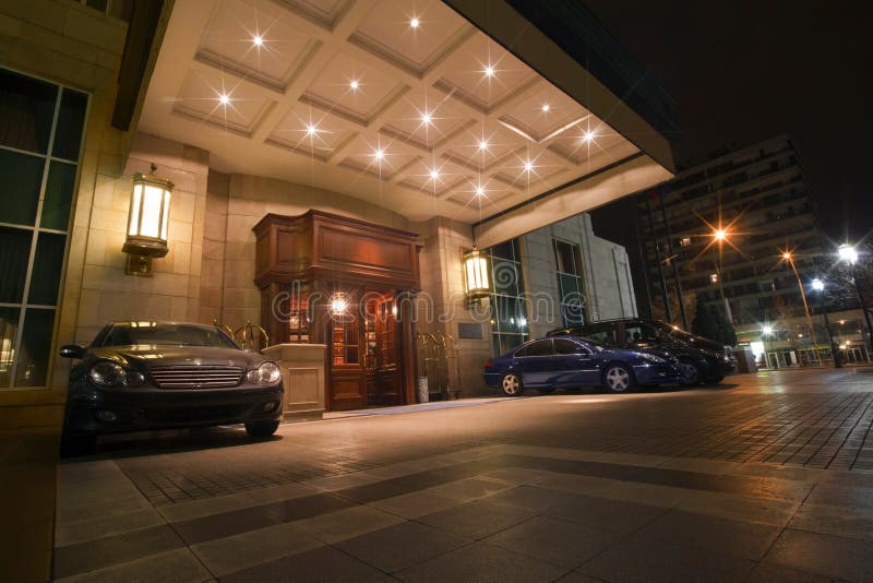 Five stars hotel front door with expensive cars parked. Five stars hotel front door with expensive cars parked.