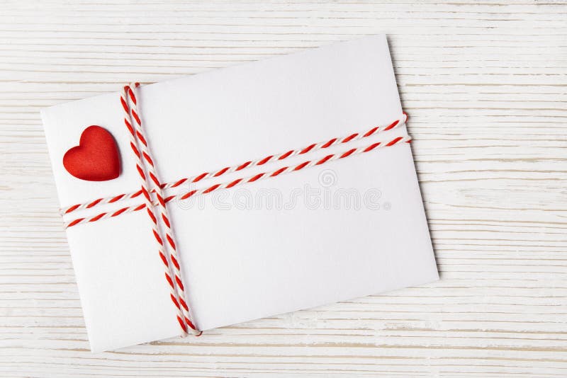 Envelope Mail with Red Heart and Ribbon over White Wooden Background. Valentine Day Card, Love or Wedding Greeting Concept. Envelope Mail with Red Heart and Ribbon over White Wooden Background. Valentine Day Card, Love or Wedding Greeting Concept