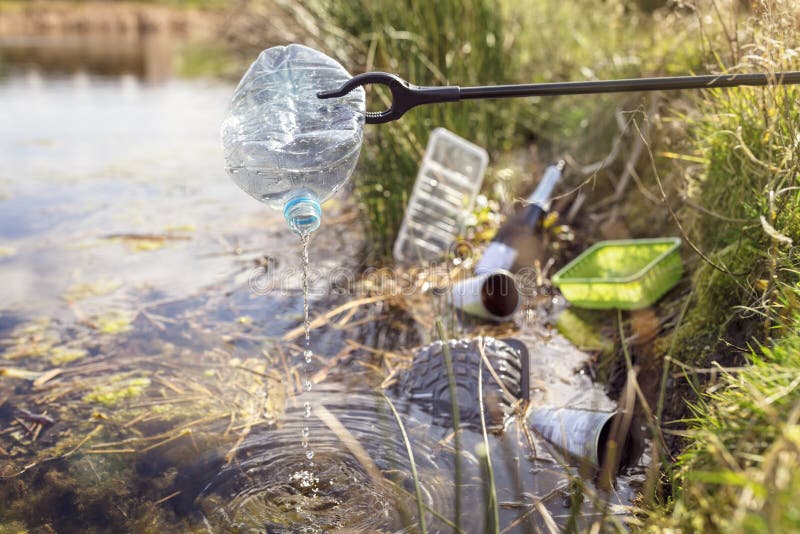 Environmental conservation collecting garbage and trash from water. Environmental conservation and pollution collecting garbage and trash from water royalty free stock photos Environmental conservation collecting garbage and trash from water. Environmental conservation and pollution collecting garbage and trash from water royalty free stock photos