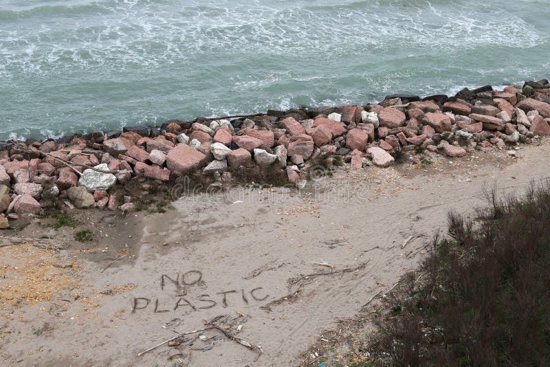 Environmental problem. Ecology concept. Plastic on the beach with sos writing. Spilled garbage on the beach royalty free stock photo Environmental problem. Ecology concept. Plastic on the beach with sos writing. Spilled garbage on the beach royalty free stock photo