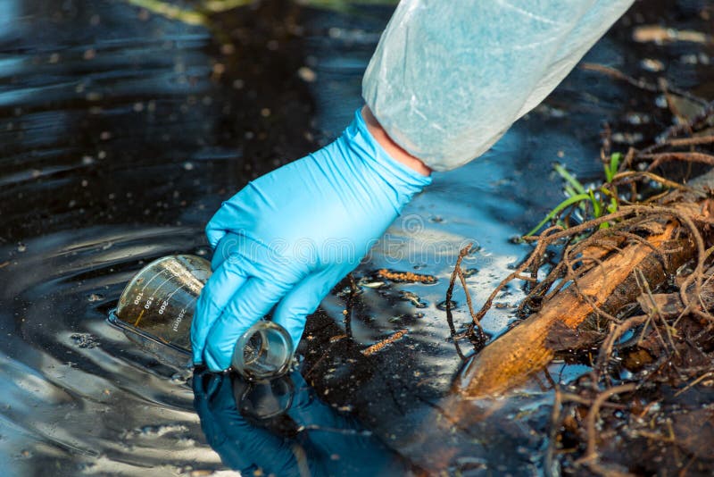 Environmentalist`s hand close up while taking a sample of water from a river royalty free stock photo Environmentalist`s hand close up while taking a sample of water from a river royalty free stock photo