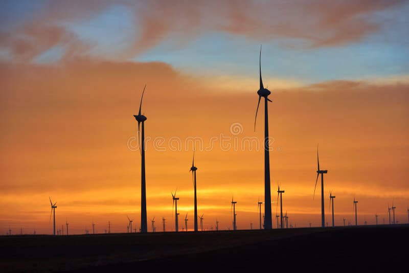 Eolian turbines park at sunet, warm light. Wind power concept royalty free stock photos Eolian turbines park at sunet, warm light. Wind power concept royalty free stock photos