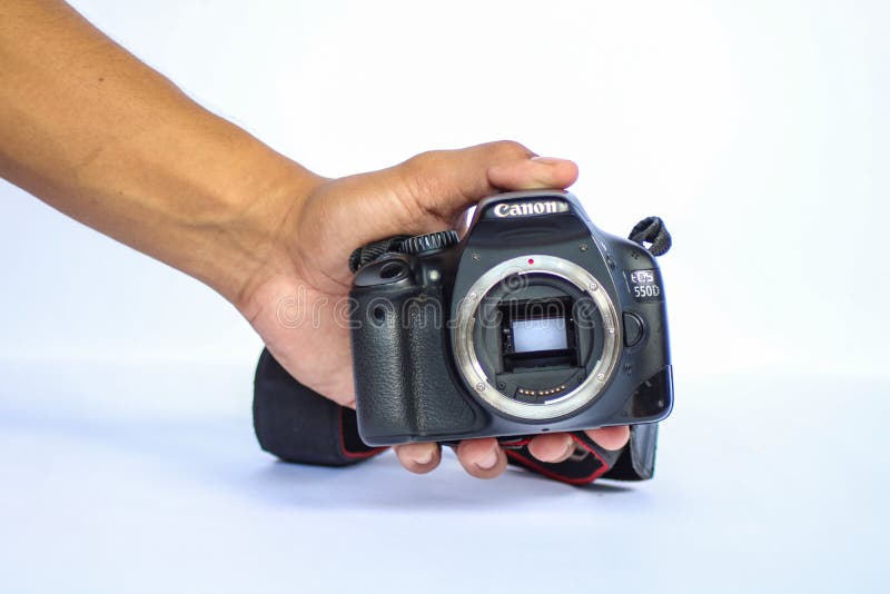 CAMARINES SUR, PHILIPPINES - OCT 28, 2018: A photo of a hand holding a used Canon EOS 550D, also known as the Rebel T2i or the Kiss X4 Digital without a lens. CAMARINES SUR, PHILIPPINES - OCT 28, 2018: A photo of a hand holding a used Canon EOS 550D, also known as the Rebel T2i or the Kiss X4 Digital without a lens