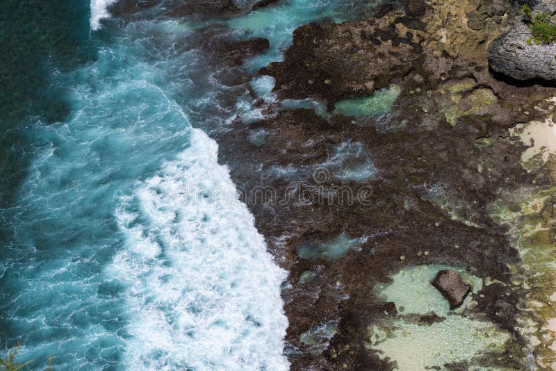 aerial view of blue ocean waves crashing into rocky coast stock image aerial view of blue ocean waves crashing into rocky coast stock image