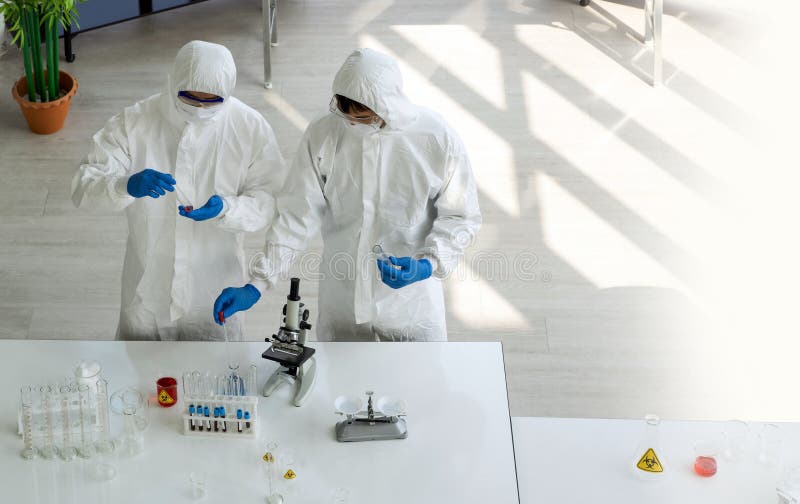 Epidemiological researcher in virus protective cloth working in laboratory. Omicron strain testing process, Coronavirus disease royalty free stock photography