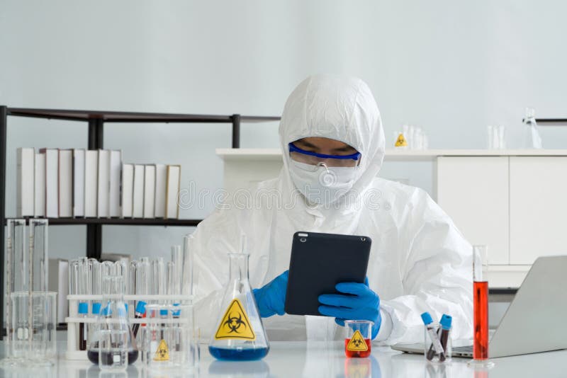 Epidemiological researcher in virus protective cloth working in laboratory. Omicron strain testing process, Coronavirus disease royalty free stock images