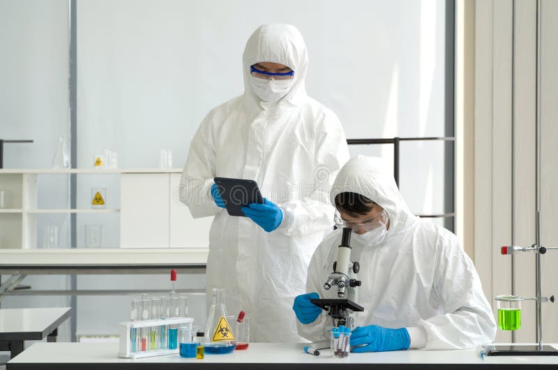 Epidemiological researcher in virus protective cloth working in laboratory. Omicron strain testing process, Coronavirus disease royalty free stock image