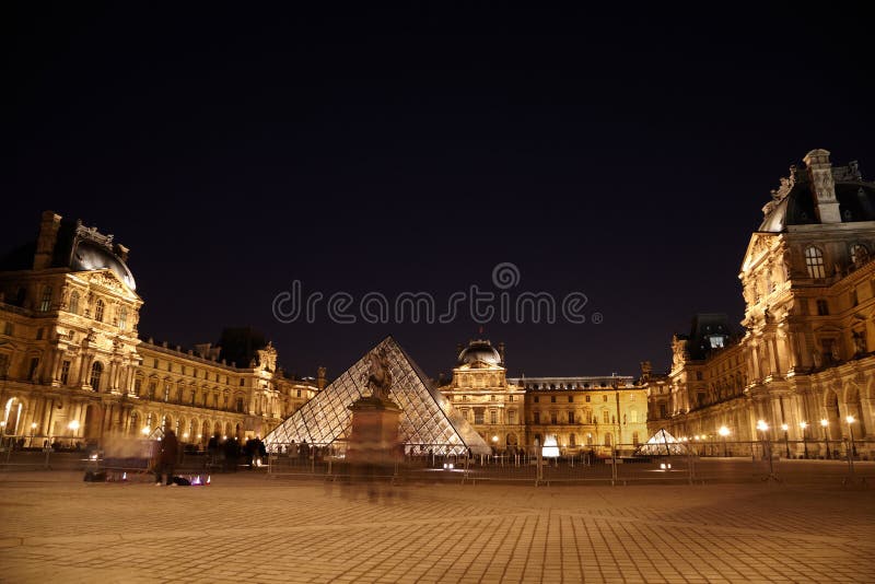 PARIS - JANUARY 1: Louvre museum, Pyramid and equestrian statue of Louis XIV in the night, January 1, 2010, Paris, France. Louis XIV equestrian statue designates a point of the beginning of a so-called historical axis of Paris. PARIS - JANUARY 1: Louvre museum, Pyramid and equestrian statue of Louis XIV in the night, January 1, 2010, Paris, France. Louis XIV equestrian statue designates a point of the beginning of a so-called historical axis of Paris.