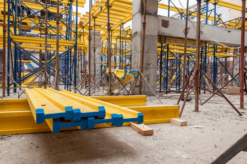 Yellow wooden beams for monolithic building construction