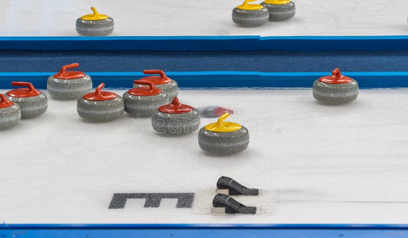 Equipment for the game of curling. selective focus. granite stone and hack on ice. royalty free stock image