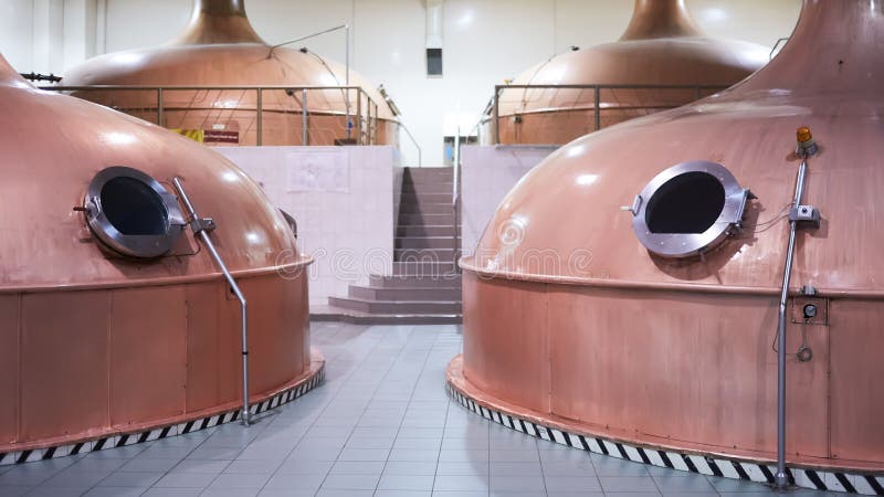 Equipment for preparation of beer. Lines of cooper tanks in brewery. Manufacturable process of brewage. Mode of beer stock image Equipment for preparation of beer. Lines of cooper tanks in brewery. Manufacturable process of brewage. Mode of beer stock image