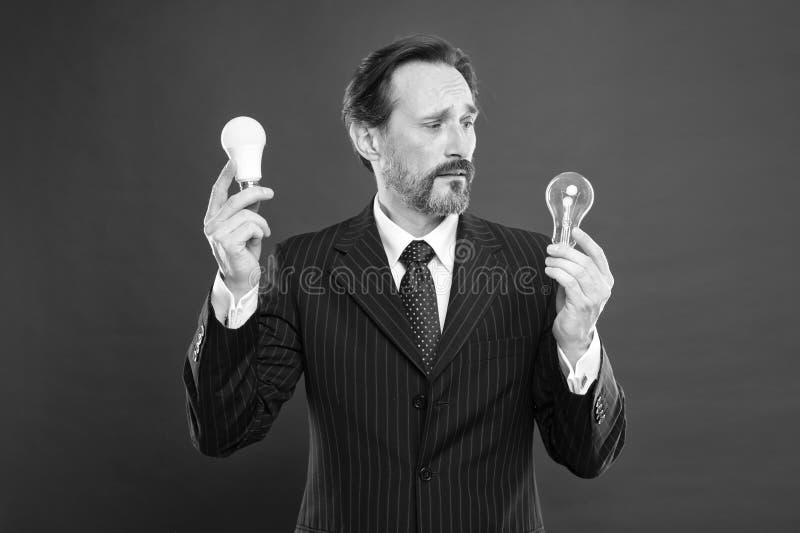 Er erhielt eine Idee Energieeinsparung verwirrter Mann in der Gesch? ftsausstattung Strom und Energie Mann mit Bartsuche nach lizenzfreies stockbild