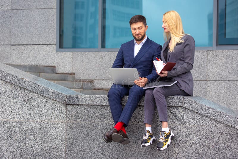 Erfolgreiche Geschäftsleute mit Dokumenten und Laptop in der Hand diskutieren Geschäftsprojekte lizenzfreies stockfoto