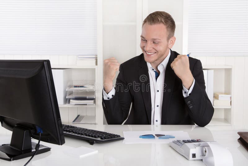 Successful young businessman proud of his success celebrating in his office. Successful young businessman proud of his success celebrating in his office.