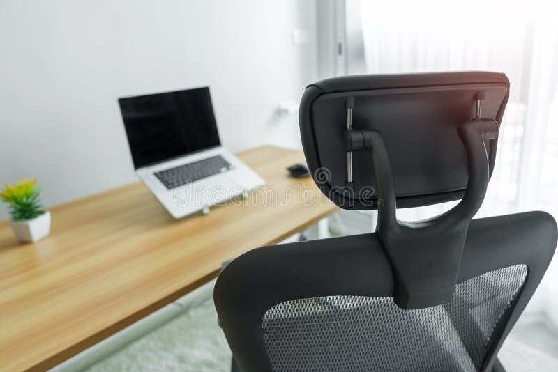 Ergonomic Chair and Adjustable Table with Laptop Computer in Modern