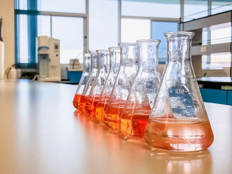 The Erlenmeyer flask in the line with color range solvent using for analysis calibration curve of iron in waste water sample royalty free stock photography