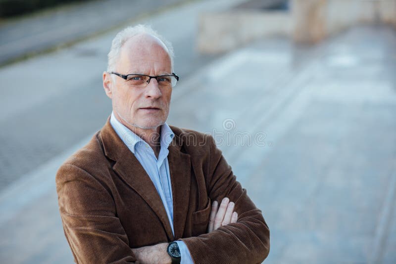 Portrait of an adult person with gray hair and eyeglasses elegant dressed outside. Portrait of an adult person with gray hair and eyeglasses elegant dressed outside