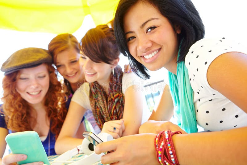 Its hard to separate a girl fro her gadgets. A group of adolescent girls laughing as they look at something on a smartphone screen. Its hard to separate a girl fro her gadgets. A group of adolescent girls laughing as they look at something on a smartphone screen