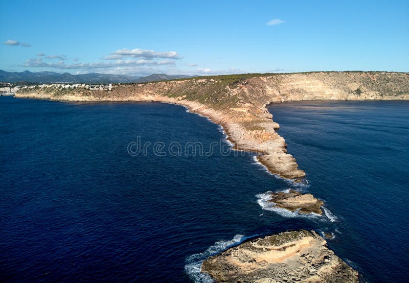 Es Ribell rocky coastline and tranquil Mediterranean Sea. Majorca, Spain