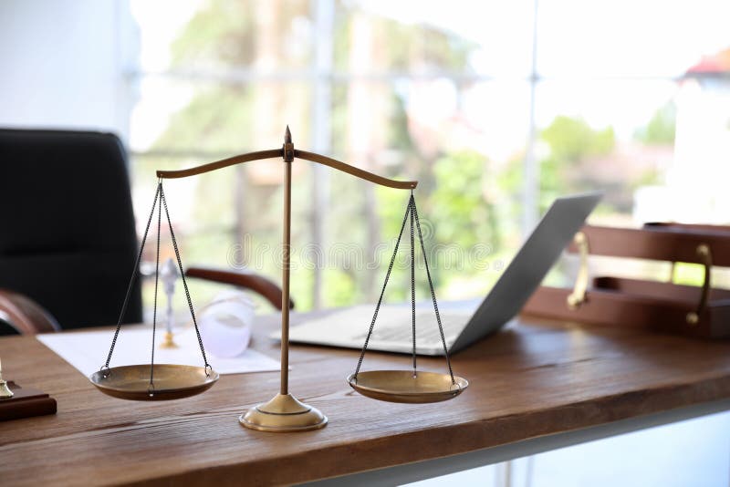 Scales of justice on desk in notary`s office. Scales of justice on desk in notary`s office