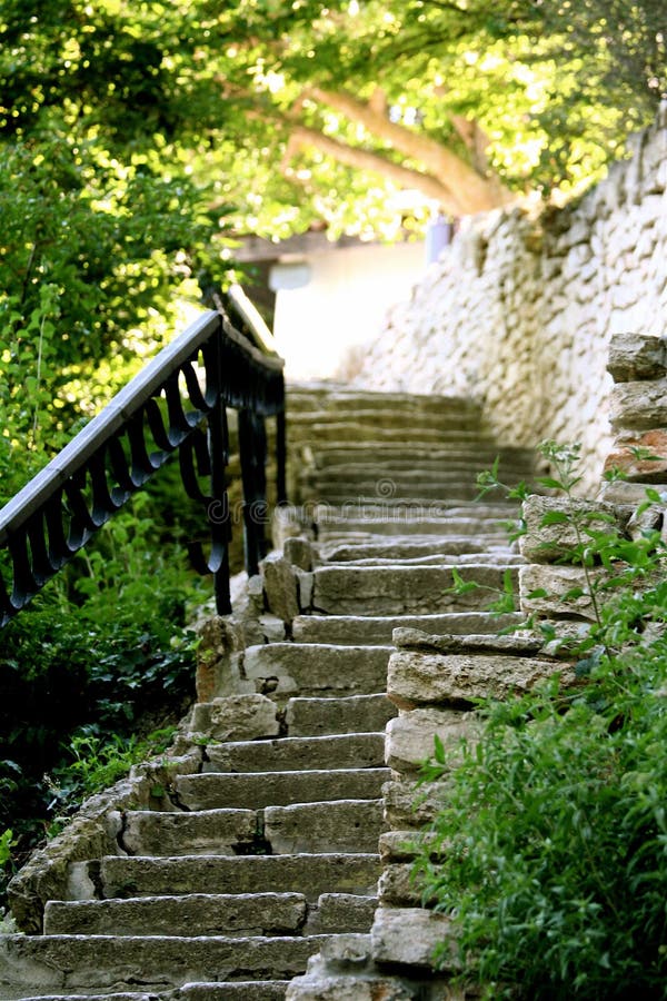 Stoned stair with ferric railing in the garden. Stoned stair with ferric railing in the garden