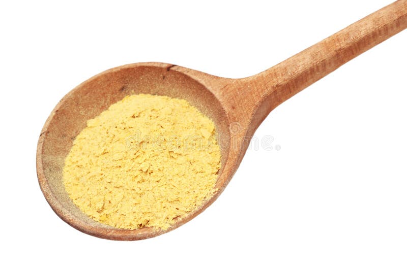 Nutritional yeast flakes in a wooden spoon isolated on white with clipping path included. Nutritional yeast flakes in a wooden spoon isolated on white with clipping path included.
