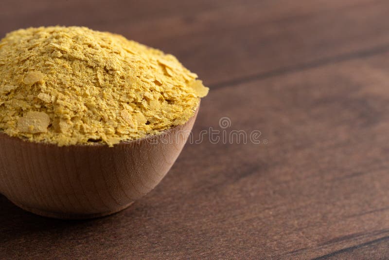 Flakes of Yellow Nutritional Yeast a Cheese Substitute and Seasoning for Vegan Cooking. Flakes of Yellow Nutritional Yeast a Cheese Substitute and Seasoning for Vegan Cooking