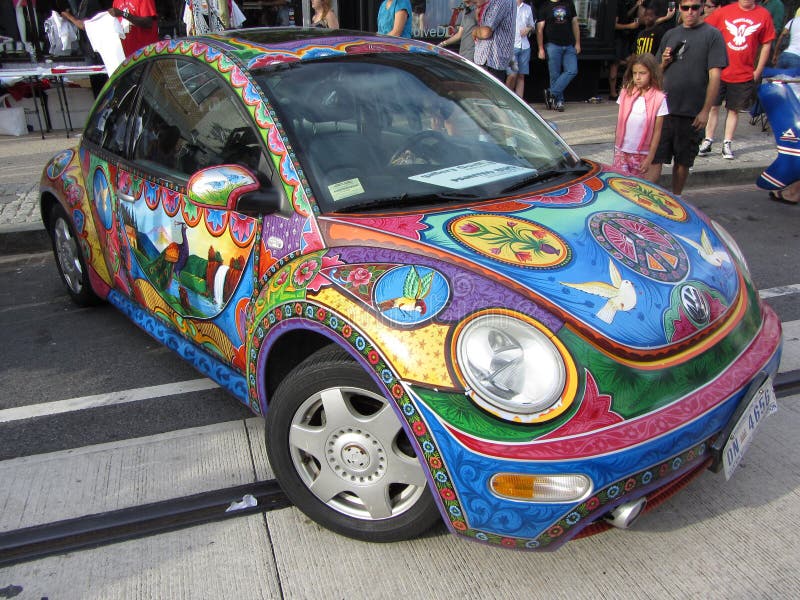 Photo of volkswagen beetle painted with artwork at the h street festival in downtown washington dc on 9/15/12. This festival takes place every year in mid september with food, arts and crafts, music, a parade, car displays, free health screenings and dance. The h street neighborhood is undergoing revitalization. Photo of volkswagen beetle painted with artwork at the h street festival in downtown washington dc on 9/15/12. This festival takes place every year in mid september with food, arts and crafts, music, a parade, car displays, free health screenings and dance. The h street neighborhood is undergoing revitalization.