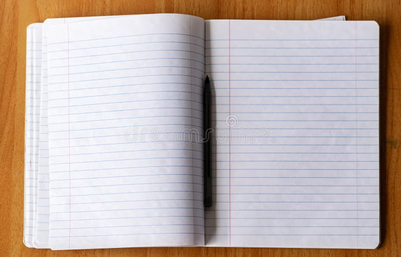 Male hand writing with pen on a lined notebook. Male hand writing with pen on a lined notebook