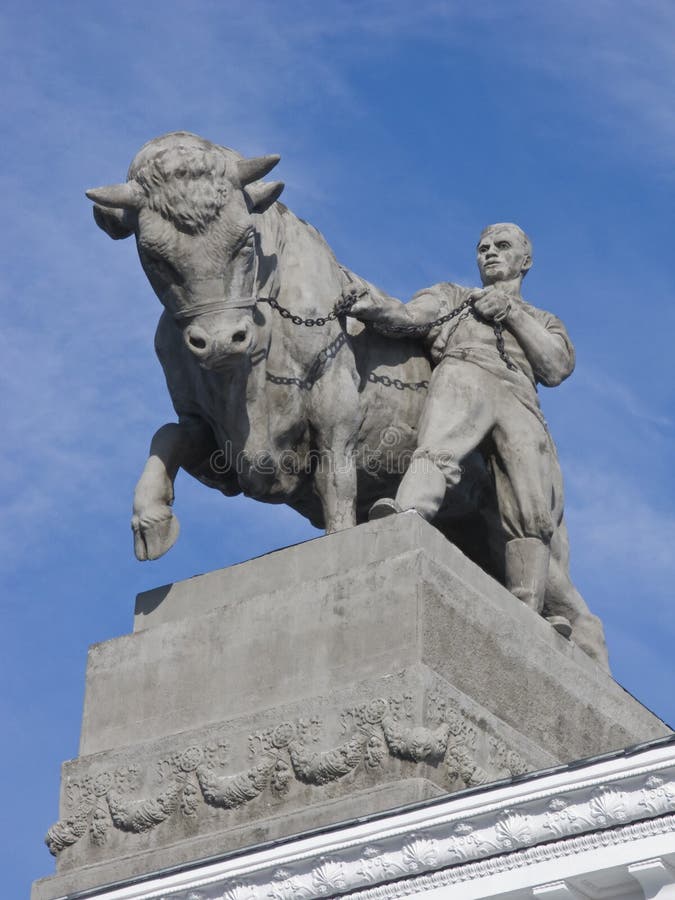 Sculpture of cattle-farm worker with a bull at agricultural exibition in Moscow, Russia. Sculpture of cattle-farm worker with a bull at agricultural exibition in Moscow, Russia