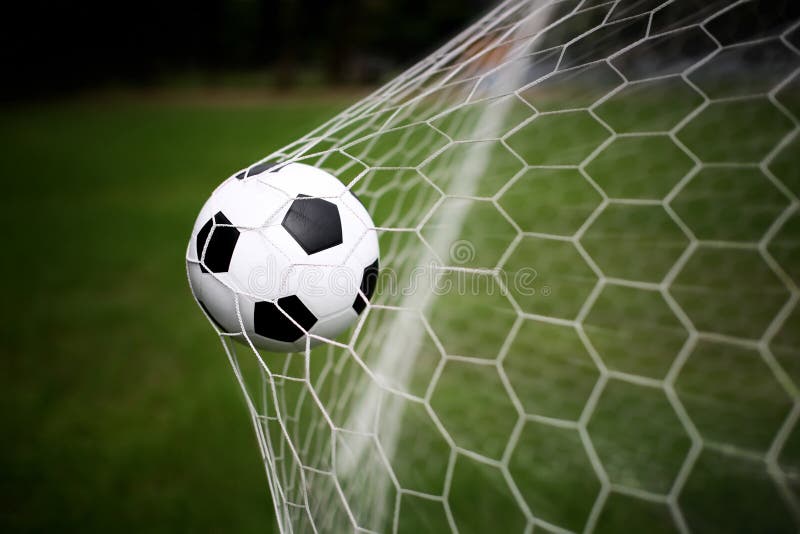 Soccer ball in goal net. Soccer ball in goal net.