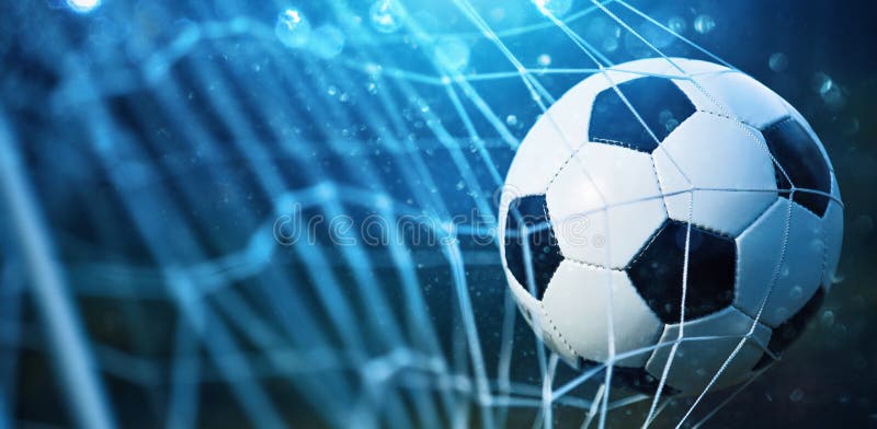 Soccer ball in goal on blue background. Soccer ball in goal on blue background