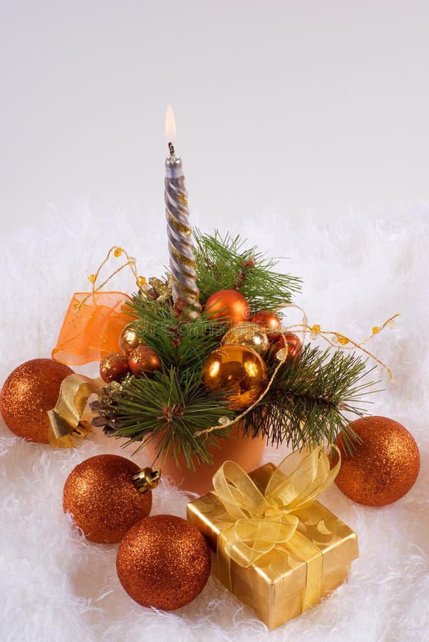 Christmas orange spheres and silver candles on the white skin. Christmas orange spheres and silver candles on the white skin