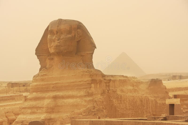 A esfinge e a pirâmide de Khafre em uma tempestade de areia, o Cairo imagens de stock royalty free A esfinge e a pirâmide de Khafre em uma tempestade de areia, o Cairo imagens de stock royalty free