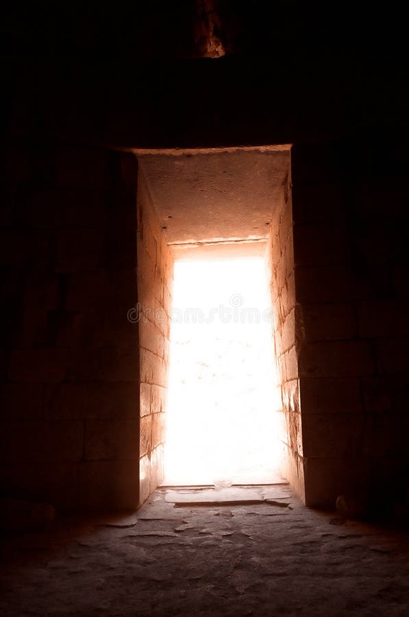 View from an ancient tomb in Mycenae. The famous vault of the Treasury of Atreus. This tholos tomb with stone dome, the largest known, was plundered in antiquity. Yopu can see that the lintel is made from 2 massive stones. The inner one weights 130 tones, while the void triangle is the symbol for the Mycenaean architecture. No other Mycenaean building can boast such exact stone cutting, nor such refined proportions; not for another 1, 000 years in Greece was such technical perfection put at the service of such a grandiose architectural design. (more). View from an ancient tomb in Mycenae. The famous vault of the Treasury of Atreus. This tholos tomb with stone dome, the largest known, was plundered in antiquity. Yopu can see that the lintel is made from 2 massive stones. The inner one weights 130 tones, while the void triangle is the symbol for the Mycenaean architecture. No other Mycenaean building can boast such exact stone cutting, nor such refined proportions; not for another 1, 000 years in Greece was such technical perfection put at the service of such a grandiose architectural design. (more)