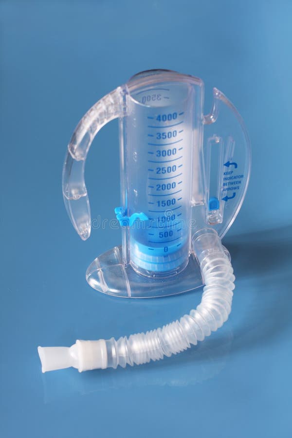 An incentive spirometer used to help patients breathe deeply and improve lung function. Patient inhales oxygen into the tube with a goal of improving breathing. An incentive spirometer used to help patients breathe deeply and improve lung function. Patient inhales oxygen into the tube with a goal of improving breathing.