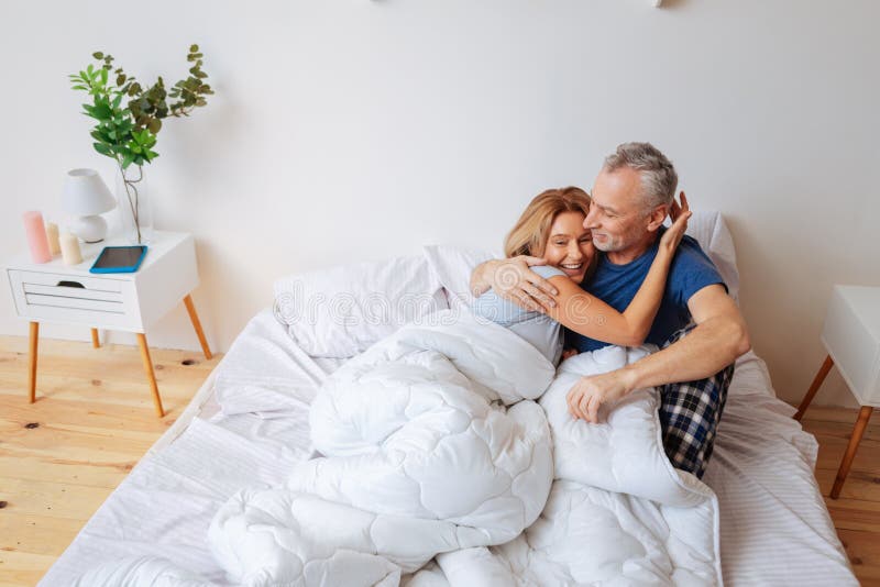 Esposa de emisión alegre que abraza a su hombre de apoyo fuerte imagen de archivo Esposa de emisión alegre que abraza a su hombre de apoyo fuerte imagen de archivo