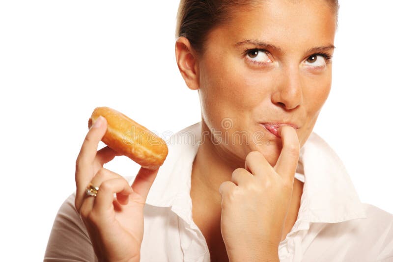 A picture of a young wife trying to resist the temptation of eating a donut. A picture of a young wife trying to resist the temptation of eating a donut