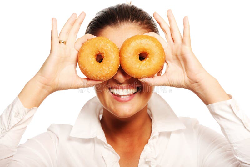 A funny picture of a young wife playing with a donut over white background. A funny picture of a young wife playing with a donut over white background