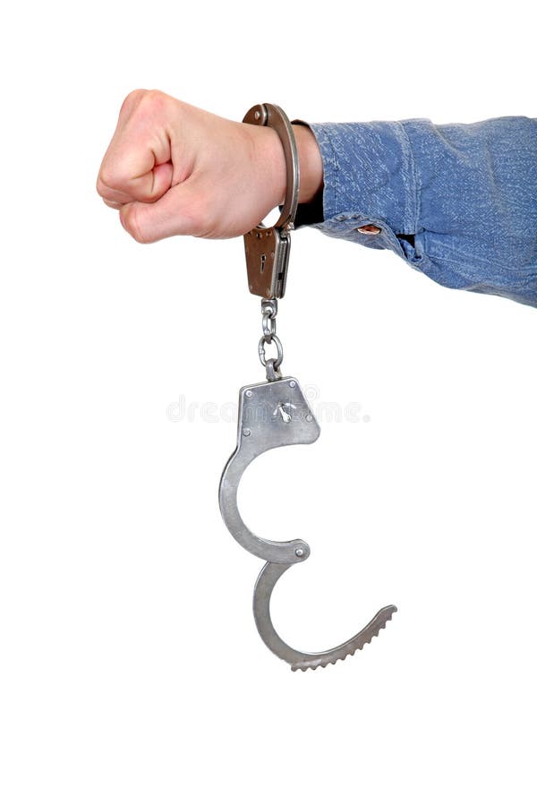 Unlocked Handcuffs hanging on a Hand Isolated on the White Background. Unlocked Handcuffs hanging on a Hand Isolated on the White Background