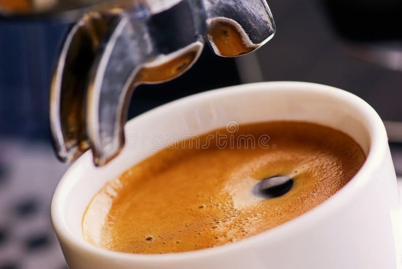 Fresh prepared espresso with great crema under a espresso machine as closeup