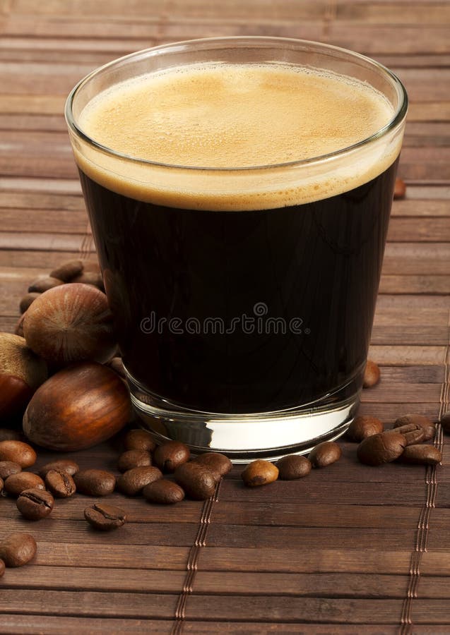 Espresso coffee in a short glass with hazelnuts