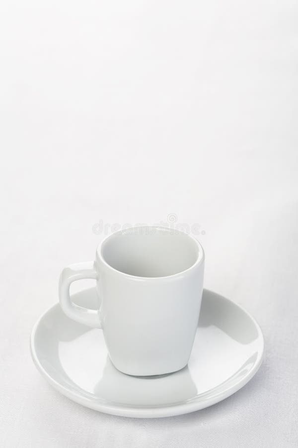 Espresso cup on white tablecloth