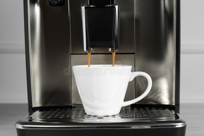 Espresso Machine Pouring Coffee into Cup on Drip Tray, Closeup Stock