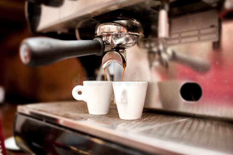 Espresso machine pouring coffee in cups stock photos Espresso machine pouring coffee in cups stock photos