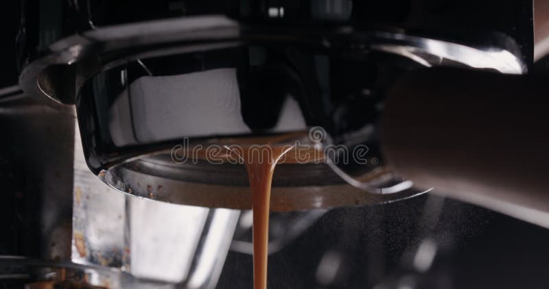 Espresso in slow motion versato dalla chiusura senza fondo portafilter