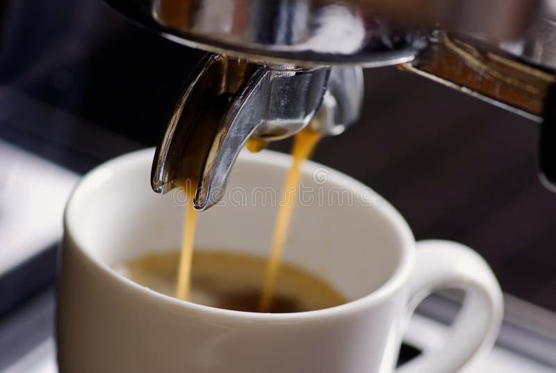 Fresh prepared espresso with great crema under a espresso machine as closeup. Fresh prepared espresso with great crema under a espresso machine as closeup