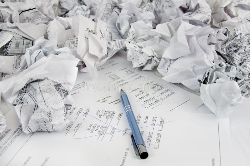 A photo shows a pen over papers after many failed attempts to make right audit The photo was shut in studio lights. A photo shows a pen over papers after many failed attempts to make right audit The photo was shut in studio lights.