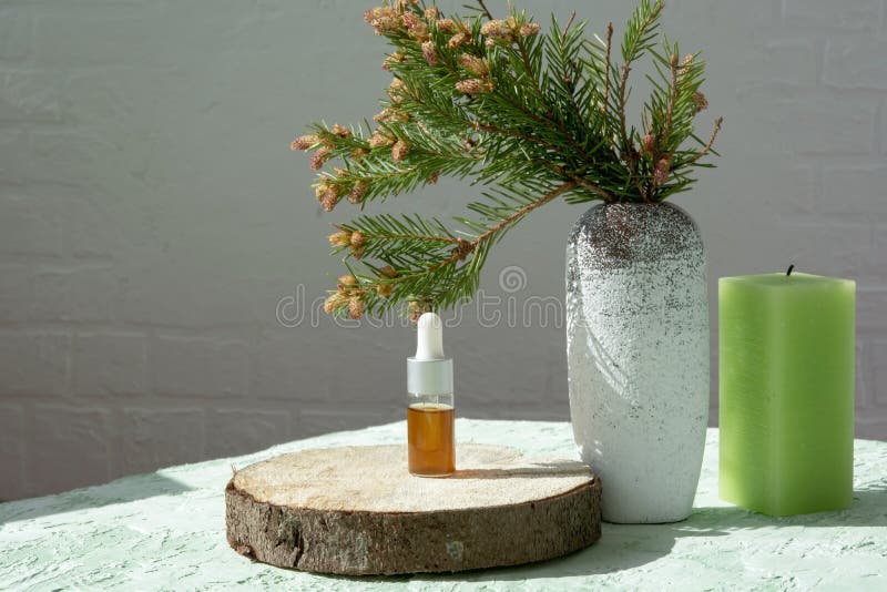 Essential Needles Extract on a Cut of a Tree with Candles Stock Image
